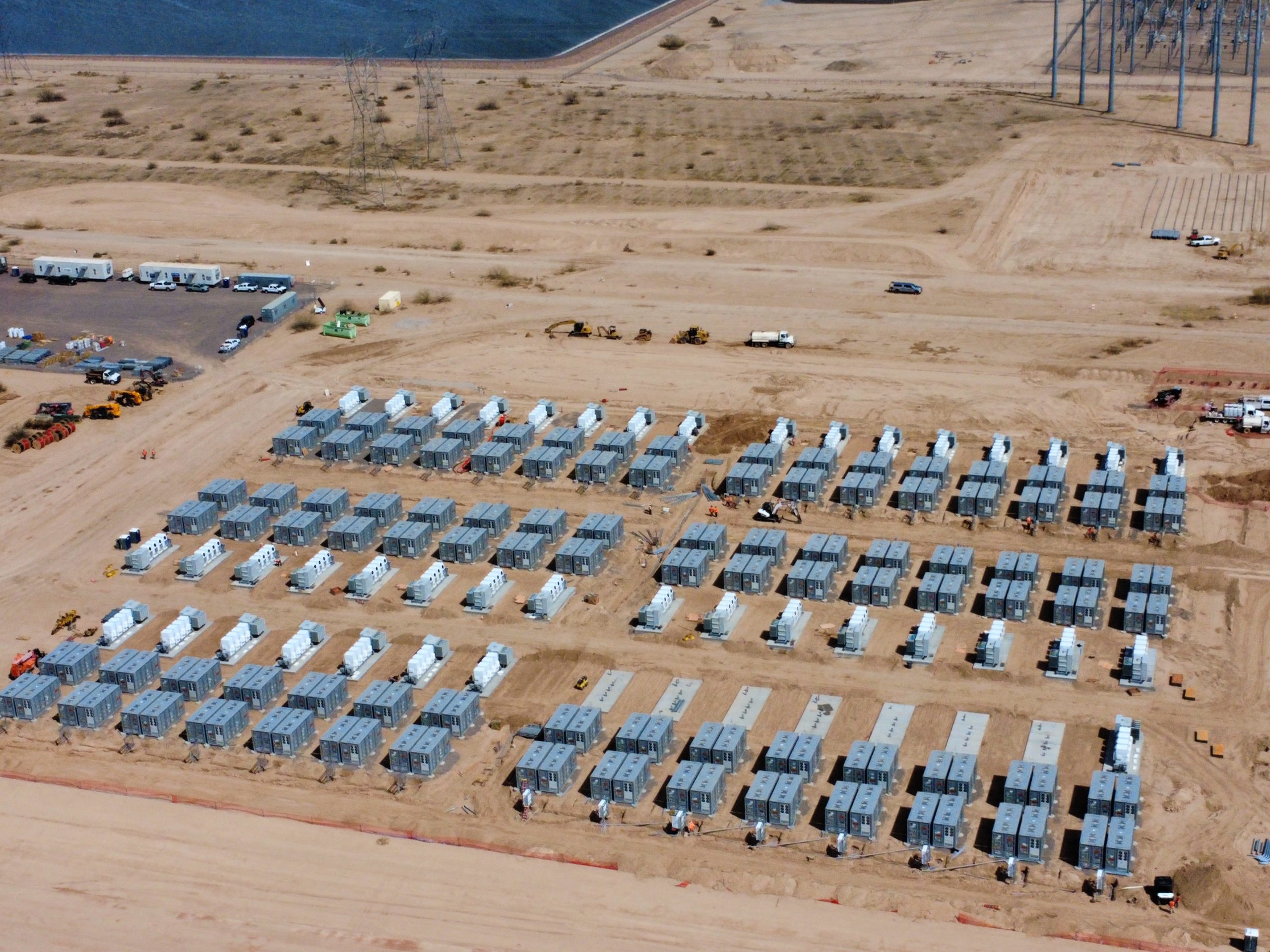 An expansive view of an electrical substation featuring large transformers and intricate high-voltage lines, indicating a complex and well-established power distribution network.